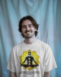 slim-man-sitting-on-sofa-wearing-tshirt-mockup1